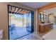 Modern kitchen with folding glass doors to an outdoor patio with beautiful mountain views at 20101 Spring Gulch Rd, Morrison, CO 80465