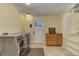 Bright laundry room featuring a modern washer and dryer, tile floor, and convenient storage cabinet at 20101 Spring Gulch Rd, Morrison, CO 80465