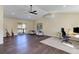 Bright living room with hardwood floors, vaulted ceilings, ceiling fan and guitars by sliding glass door at 20101 Spring Gulch Rd, Morrison, CO 80465