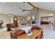 Bright open living room with stone fireplace, wood beams, and leather couches at 20101 Spring Gulch Rd, Morrison, CO 80465
