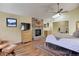 Comfortable main bedroom featuring a fireplace with stone accents, a skylight, and a ceiling fan at 20101 Spring Gulch Rd, Morrison, CO 80465