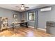 Functional office with desk, shelving, hardwood floors, and great natural light from the window at 20101 Spring Gulch Rd, Morrison, CO 80465