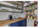 A spacious pantry with wooden countertops, navy blue cabinets, and open shelving provides ample storage at 20101 Spring Gulch Rd, Morrison, CO 80465