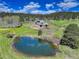 Idyllic property featuring a serene pond with swans and a beautifully landscaped home nestled in a lush, green setting at 20101 Spring Gulch Rd, Morrison, CO 80465