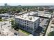 An aerial view of the apartment building shows parking and green space in a vibrant urban setting at 277 N Broadway # 403, Denver, CO 80203