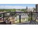 Balcony view with an ornate black fence overlooking a neighborhood with mature trees at 277 N Broadway # 403, Denver, CO 80203