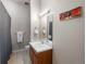 Bright bathroom offers vanity with a mirror, a painting, and tile floors for a comfortable home environment at 277 N Broadway # 403, Denver, CO 80203