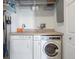 An efficient laundry area with side by side washer and dryer and storage is bright and clean at 277 N Broadway # 403, Denver, CO 80203