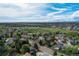 Breathtaking aerial view of neighborhood with mature trees, green spaces, and clear skies at 6302 S Ivy Ct, Centennial, CO 80111