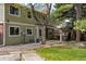 Back exterior view of the house with a patio area, second story deck, and mature trees at 6302 S Ivy Ct, Centennial, CO 80111