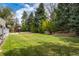 Expansive backyard featuring a lush lawn, mature trees, and a fence, perfect for outdoor activities and relaxation at 6302 S Ivy Ct, Centennial, CO 80111