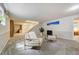 Finished basement living area with a staircase, comfortable seating, and natural light, creating an inviting space at 6302 S Ivy Ct, Centennial, CO 80111