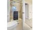Bathroom with stand-up shower and glass doors, tile flooring, with modern fixtures and a view into the carpeted hallway at 6302 S Ivy Ct, Centennial, CO 80111