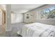 Bright bedroom featuring two windows, plush carpeting, and a walk-in closet for organized storage and calm space at 6302 S Ivy Ct, Centennial, CO 80111