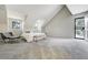 Expansive bedroom with neutral carpet, multiple windows, and decorative glass panel door at 6302 S Ivy Ct, Centennial, CO 80111