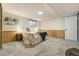 Cozy bedroom with plush carpet, paneled walls, and a comfortable queen-sized bed with stylish lamps on side tables at 6302 S Ivy Ct, Centennial, CO 80111