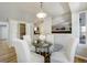 Cozy dining room area features glass-top table, 4 chairs, and convenient access to a pantry at 6302 S Ivy Ct, Centennial, CO 80111