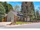 Charming two-story brick home with a well-manicured lawn, mature trees, and an attached two-car garage at 6302 S Ivy Ct, Centennial, CO 80111