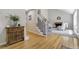 Inviting foyer featuring hardwood floors, a staircase with wrought iron railings, and a glimpse of the living room at 6302 S Ivy Ct, Centennial, CO 80111