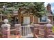Charming brick home with mature landscaping and a quaint gate, offering a welcoming curb appeal at 6302 S Ivy Ct, Centennial, CO 80111