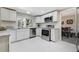 Modern kitchen with white cabinetry, stainless steel appliances, granite countertops, and bright natural light at 6302 S Ivy Ct, Centennial, CO 80111