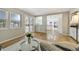 Bright living room features refinished hardwood floors, large windows, and decorative glass panel doors at 6302 S Ivy Ct, Centennial, CO 80111