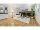 Sunlit living room boasts a brick fireplace, hardwood floors, and stylish decor at 6302 S Ivy Ct, Centennial, CO 80111