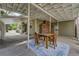 Covered patio featuring a rustic dining table and chairs, perfect for outdoor entertaining and dining at 6302 S Ivy Ct, Centennial, CO 80111