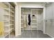 Spacious walk-in closet featuring ample shelving and storage space for organized living, carpet flooring, and neutral paint at 6302 S Ivy Ct, Centennial, CO 80111