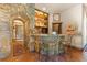 Charming bar area with stone accents, custom shelving, and seating for entertaining at 142 Outpost Ln, Evergreen, CO 80439