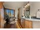 Bright bathroom with a freestanding tub, walk-in shower, stone countertop, and wood floors at 142 Outpost Ln, Evergreen, CO 80439