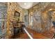 Cozy stone breakfast nook with small table and chairs at 142 Outpost Ln, Evergreen, CO 80439