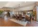 Elegant dining room with stone walls, hardwood floors, and a large table at 142 Outpost Ln, Evergreen, CO 80439