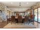 Elegant dining room with stone walls, hardwood floors and large windows at 142 Outpost Ln, Evergreen, CO 80439