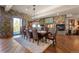 Rustic-chic dining room with stone walls, hardwood floors, and a large table at 142 Outpost Ln, Evergreen, CO 80439