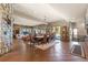 Spacious dining room features wood floors, stone walls, and a large window overlooking the outdoors at 142 Outpost Ln, Evergreen, CO 80439