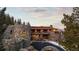 Picturesque home with stone facade, offering luxurious mountain living with incredible views at 142 Outpost Ln, Evergreen, CO 80439