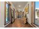 Long hallway with wood floors, large windows, and stone accents at 142 Outpost Ln, Evergreen, CO 80439