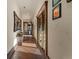 Hallway with hardwood floors, textured walls, and access to multiple rooms at 142 Outpost Ln, Evergreen, CO 80439