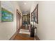 Hallway featuring a view of the living room and an ornate mirror above a wooden table at 142 Outpost Ln, Evergreen, CO 80439