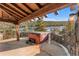 Inviting hot tub on a stone patio with an amazing forest view and rustic wood beams at 142 Outpost Ln, Evergreen, CO 80439