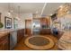 Open kitchen showcasing wood floors, stainless steel appliances and stone accent wall at 142 Outpost Ln, Evergreen, CO 80439