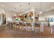 Spacious kitchen with stone accents, island seating, and hardwood floors at 142 Outpost Ln, Evergreen, CO 80439