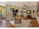 Cozy living room features a stone fireplace and hardwood floors at 142 Outpost Ln, Evergreen, CO 80439