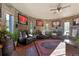 Unique living room with stone walls, hockey memorabilia, hardwood floors and comfortable leather seating at 142 Outpost Ln, Evergreen, CO 80439