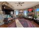 Unique living room with stone walls, hockey memorabilia, and comfortable leather seating at 142 Outpost Ln, Evergreen, CO 80439