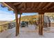 Inviting outdoor patio with fireplace, views of nature, and dining perfect for entertaining guests at 142 Outpost Ln, Evergreen, CO 80439