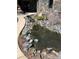 Front yard with tranquil water feature, rock accents, and natural landscaping creating a peaceful entry to the home at 142 Outpost Ln, Evergreen, CO 80439