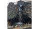 Stone waterfall feature that adds to the serenity of this property at 142 Outpost Ln, Evergreen, CO 80439