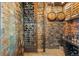 Rustic wine cellar with stone walls, custom wine racks, and space for storage and display at 142 Outpost Ln, Evergreen, CO 80439